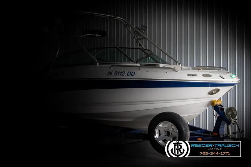 Slide: The Image of 2005 Crownline 216 LS boat on trailer in dimly lit storage. - 3