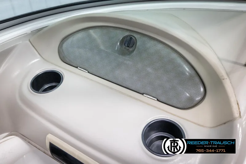 Slide: The Image of 2005 Crownline 216 LS boat interior with cup holders and storage compartment. - 31