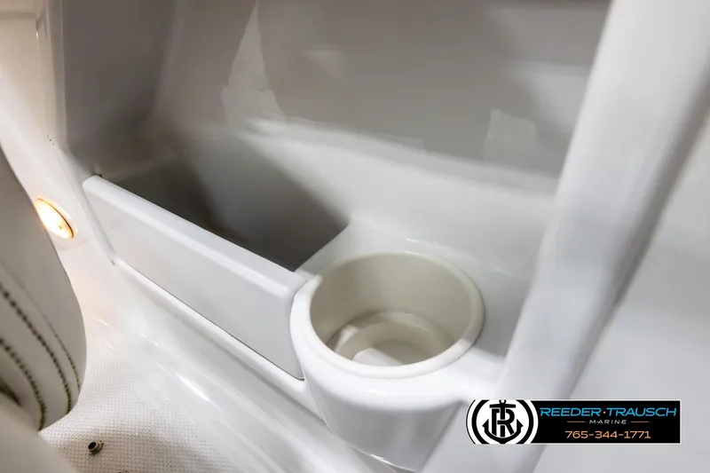 Slide: The Image of 2005 Crownline 216 LS boat interior with cup holder and storage compartment. - 36