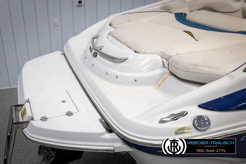 Slide: The Image of 2005 Crownline 216 LS boat with white and blue detailing, rear view. - 46