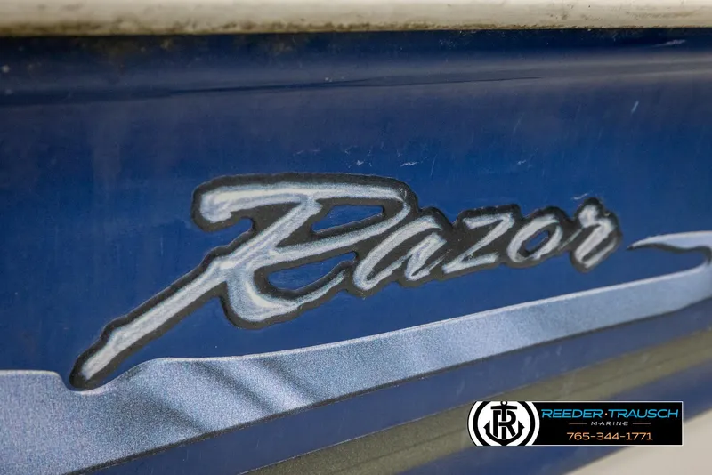 Slide: The Image of 2005 Crownline 216 LS boat with "Razor" logo on blue hull. - 47