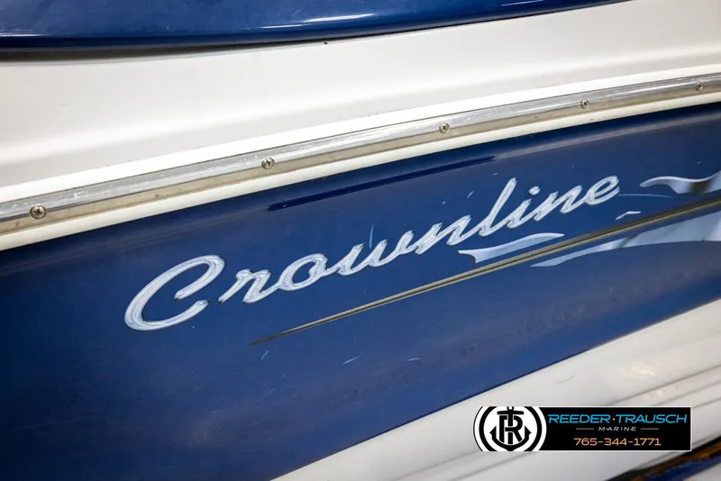 Slide: The Image of 2005 Crownline 216 LS boat, blue and white exterior, Reeder-Trausch Marine logo visible. - 49