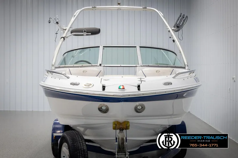 Slide: The Image of 2005 Crownline 216 LS boat on trailer in indoor showroom. - 7