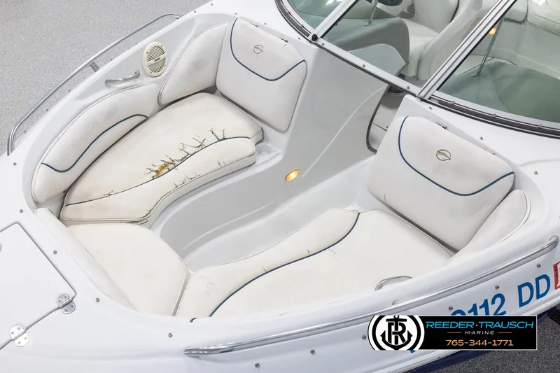 Slide: The Image of 2005 Crownline 216 LS boat interior with white seating and blue trim. - 9