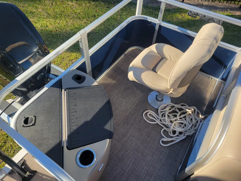 Slide: The Image of 2023 Sun Tracker Bass Buggy 18 DLX interior with seating and rope on deck. - 10