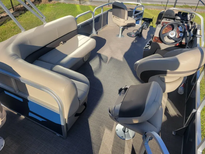 Slide: The Image of 2023 Sun Tracker Bass Buggy 18 DLX pontoon boat interior with seating and steering console. - 11