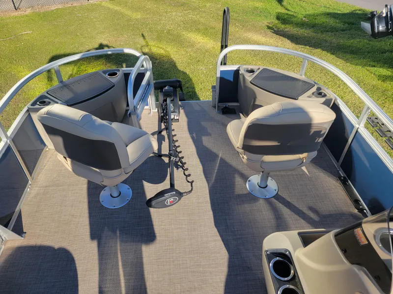Slide: The Image of 2023 Sun Tracker Bass Buggy 18 DLX pontoon boat interior with seating and fishing setup. - 13