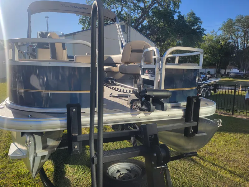 Slide: The Image of 2023 Sun Tracker Bass Buggy 18 DLX pontoon boat on display outdoors. - 6