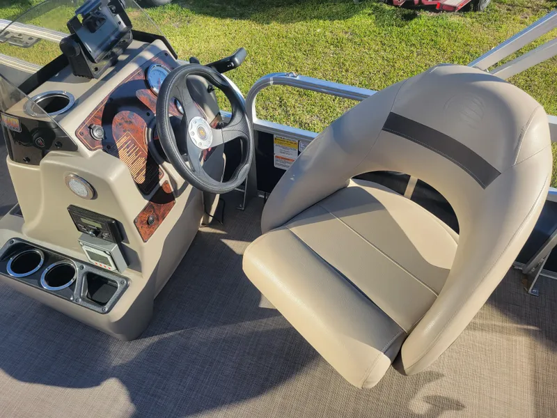 Slide: The Image of 2023 Sun Tracker Bass Buggy 18 DLX boat interior with steering console and captain's chair. - 9