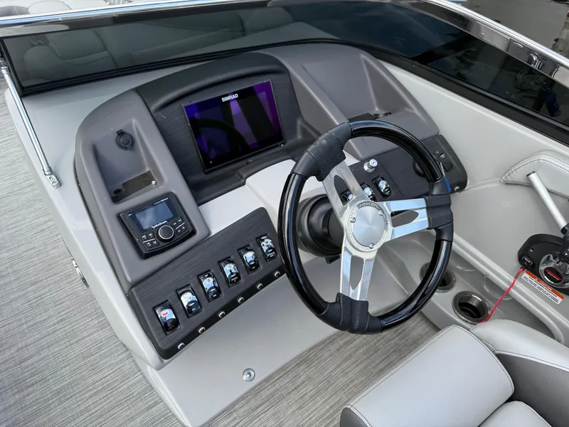 Slide: The Image of 2020 Bennington R 25 RFBWA Fastback boat dashboard with steering wheel and control panel. - 13