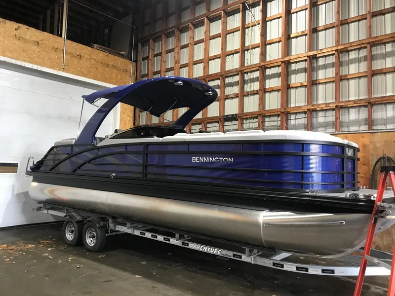 Slide: The Image of 2020 Bennington R 25 RFBWA Fastback pontoon boat in storage on trailer. - 3