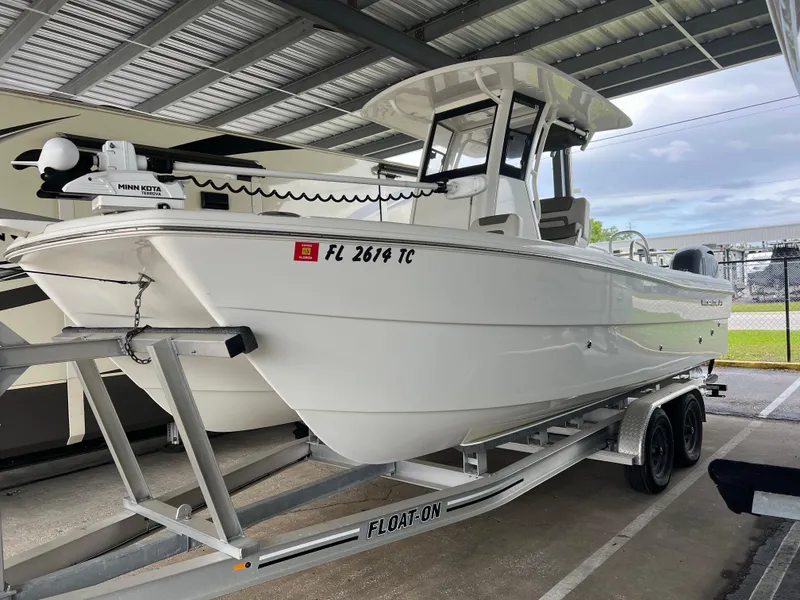 The Image of 2022 World Cat 235 CC boat on trailer under shelter. - 0