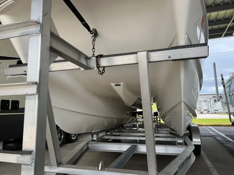 Slide: The Image of 2022 World Cat 235 CC boat on trailer, viewed from below in storage facility. - 2