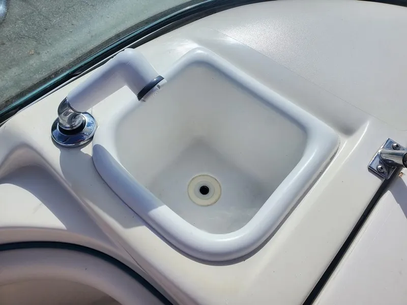 Slide: The Image of 1998 Sea Ray 210 Sundeck boat sink with faucet, white interior. - 10