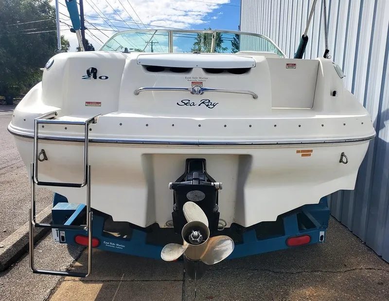 Slide: The Image of 1998 Sea Ray 210 Sundeck boat rear view with propeller and ladder. - 13