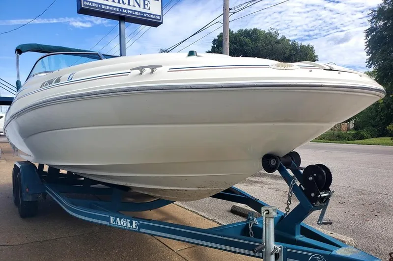 Slide: The Image of 1998 Sea Ray 210 Sundeck boat on trailer, parked outdoors. - 17