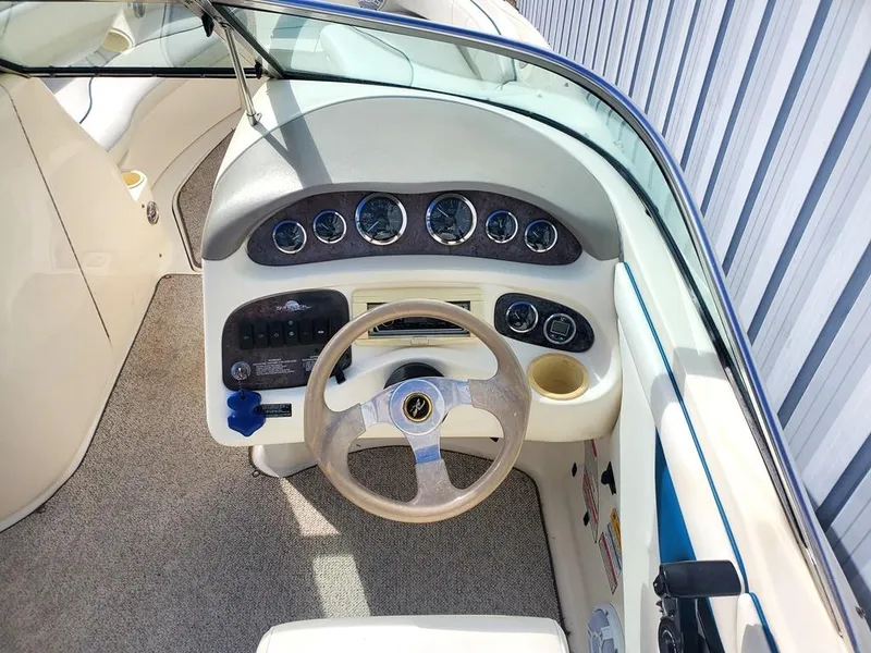 Slide: The Image of 1998 Sea Ray 210 Sundeck dashboard with steering wheel and instrument panel. - 20