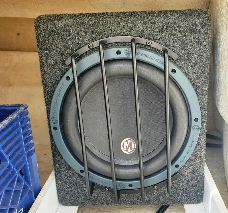Slide: The Image of Subwoofer in a 1998 Sea Ray 210 Sundeck boat, featuring protective grille. - 23