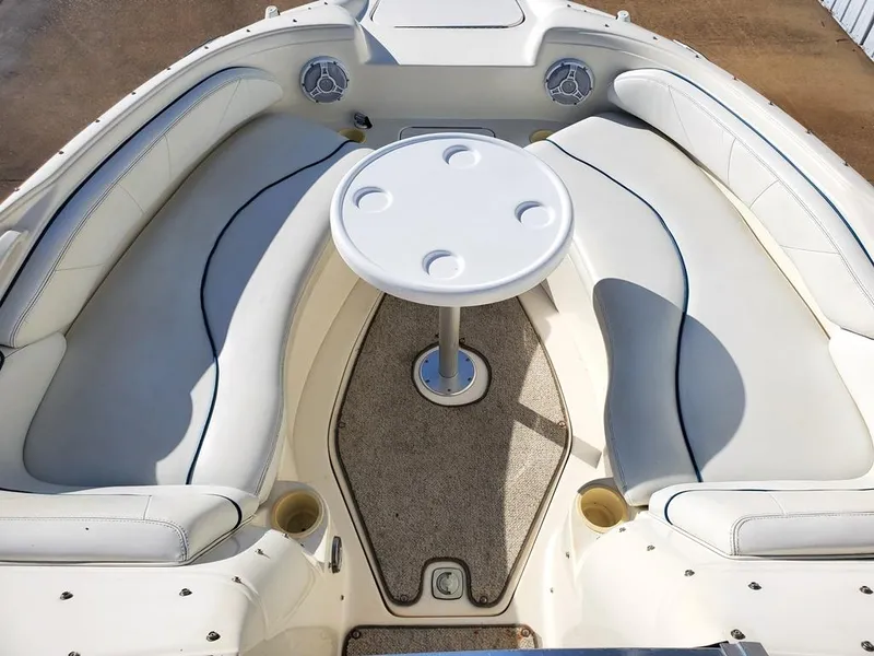 Slide: The Image of 1998 Sea Ray 210 Sundeck interior with white seating and round table. - 5