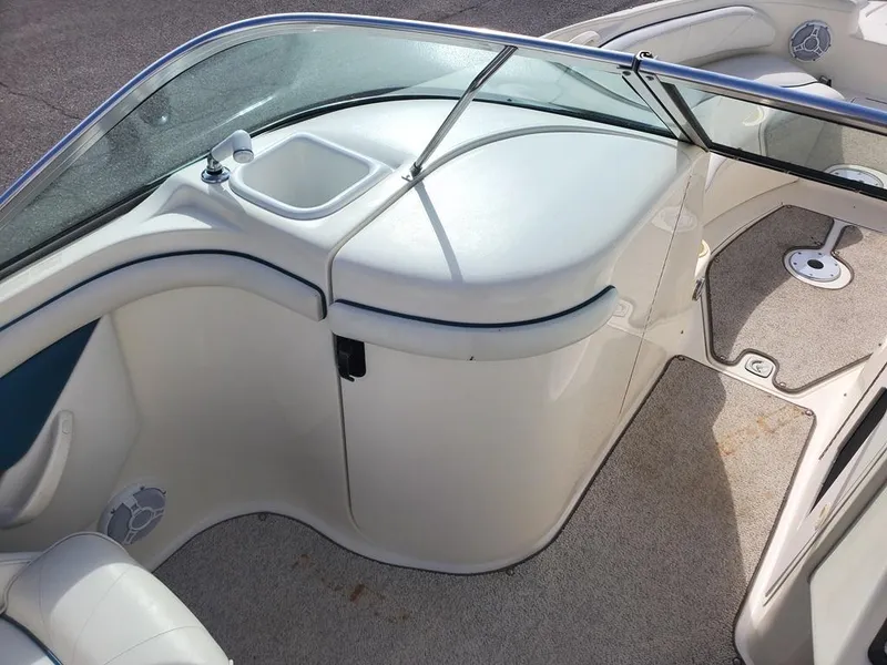 Slide: The Image of Interior view of a 1998 Sea Ray 210 Sundeck boat, featuring seating and storage. - 9