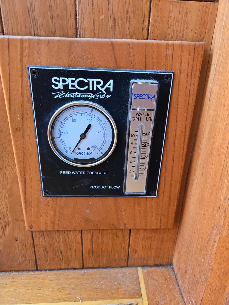Slide: The Image of Spectra watermaker gauge on 1980 Shannon 38 PH boat, showing feed water pressure and flow rate. - 10