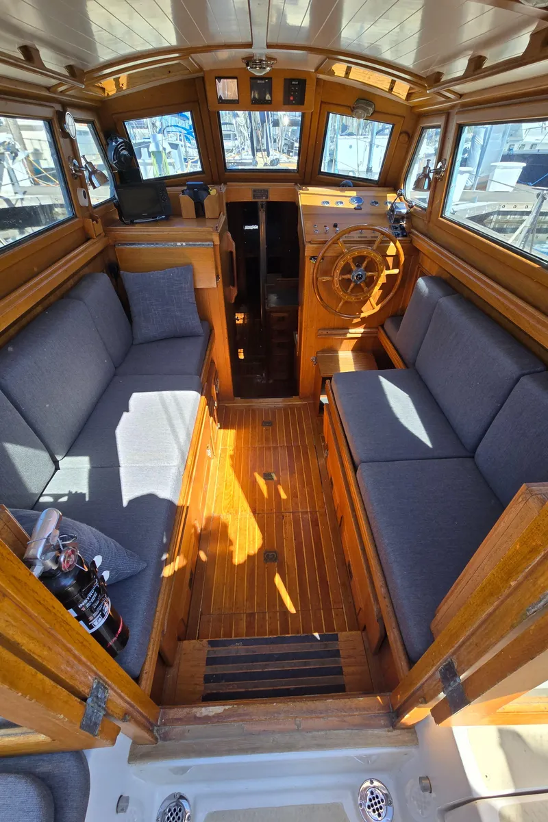Slide: The Image of 1980 Shannon 38 PH boat interior with wooden finish and cushioned seating. - 12