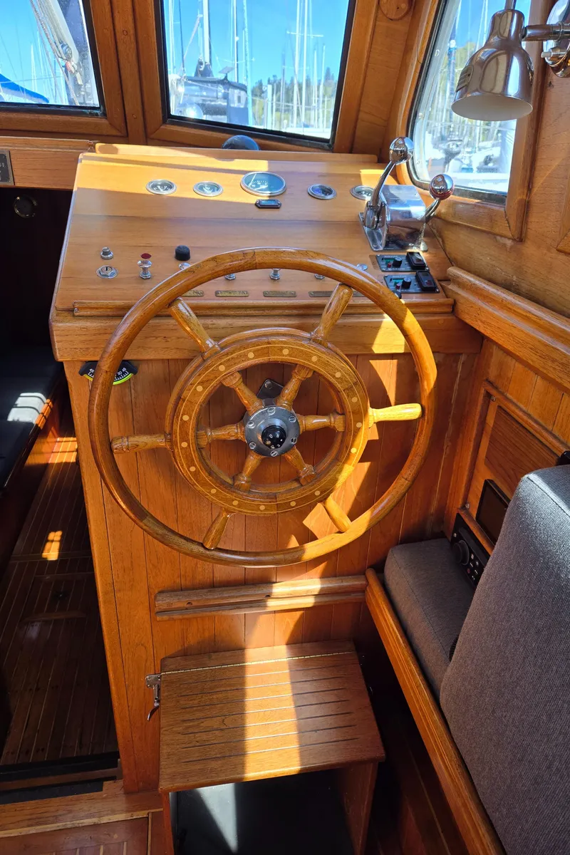 Slide: The Image of Wooden helm of 1980 Shannon 38 PH boat with classic steering wheel and controls. - 13