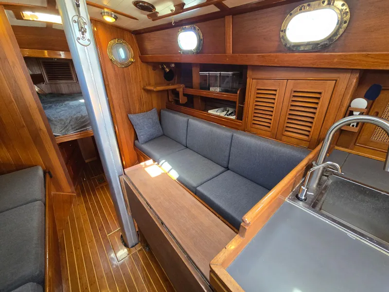 Slide: The Image of Cozy interior of 1980 Shannon 38 PH sailboat with wooden finishes and blue seating. - 16