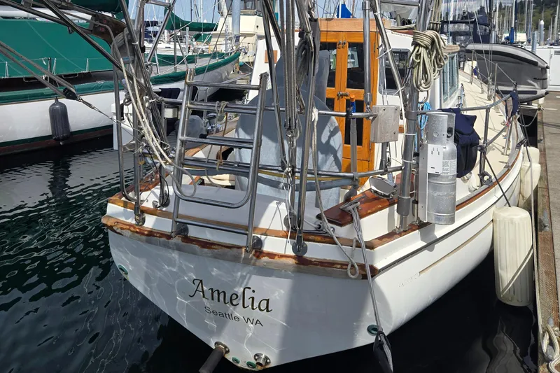 Slide: The Image of 1980 Shannon 38 PH sailboat named "Amelia" docked in Seattle marina. - 2