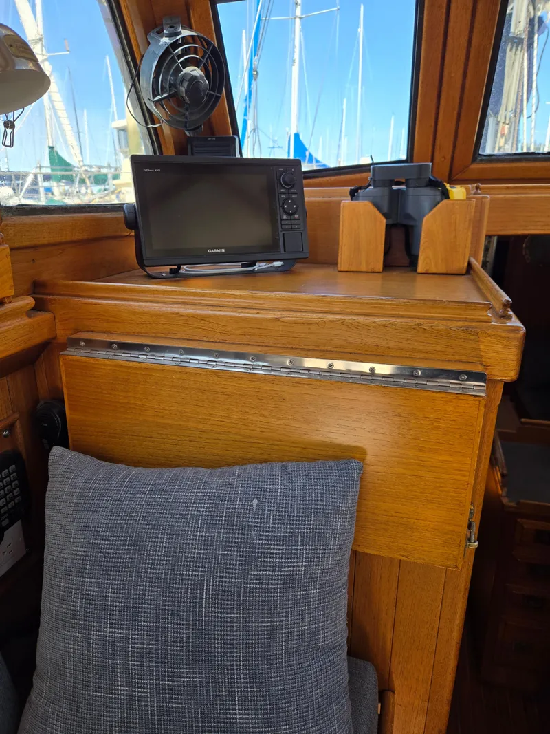 Slide: The Image of 1980 Shannon 38 PH interior with navigation equipment and wooden cabinetry. - 20