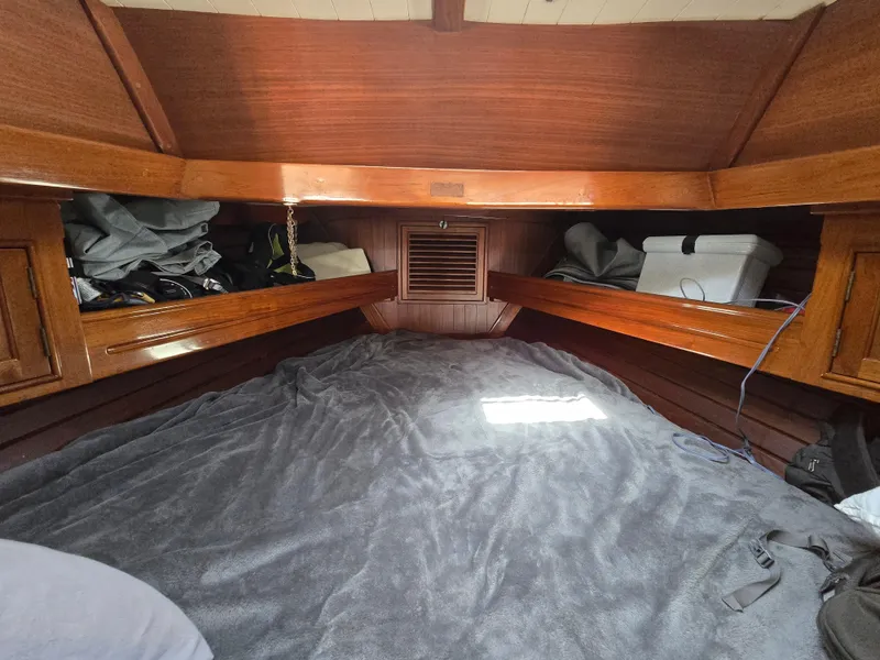 Slide: The Image of Cozy cabin interior of 1980 Shannon 38 PH sailboat with wooden finish and storage. - 22