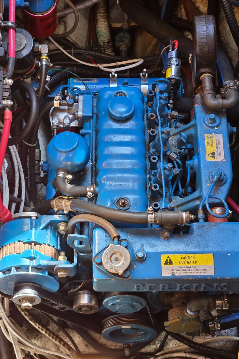 Slide: The Image of Engine of a 1980 Shannon 38 PH boat, featuring blue components and visible wiring. - 26