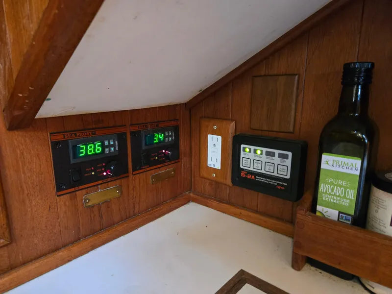 Slide: The Image of Control panel and avocado oil in a 1980 Shannon 38 PH boat interior. - 27