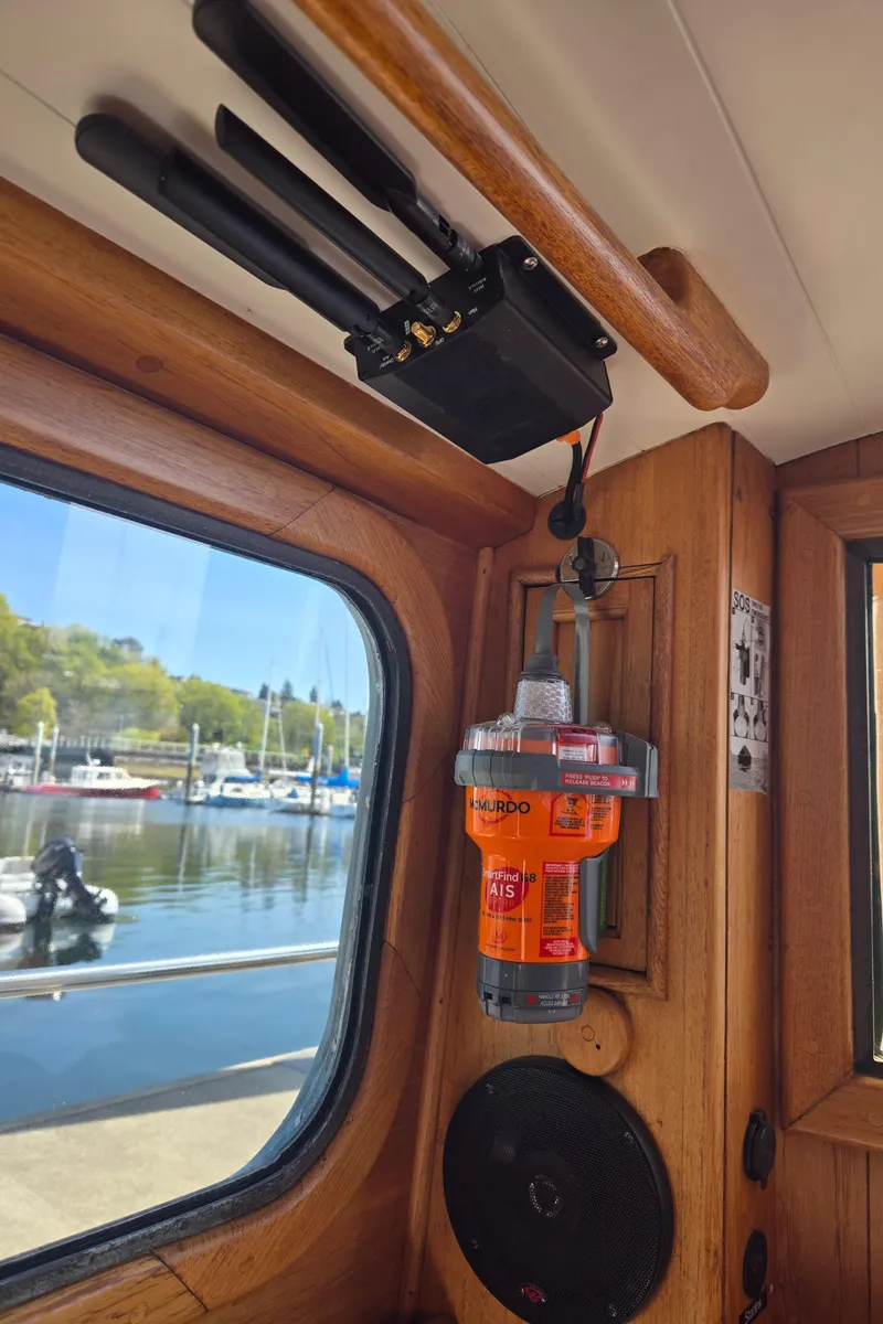 Slide: The Image of Interior of 1980 Shannon 38 PH boat with emergency equipment and marina view. - 28