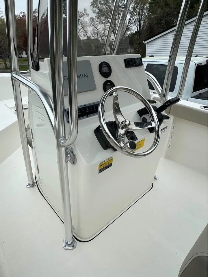 Slide: The Image of 2023 Key West 203 FS boat console with steering wheel and Garmin display. - 5