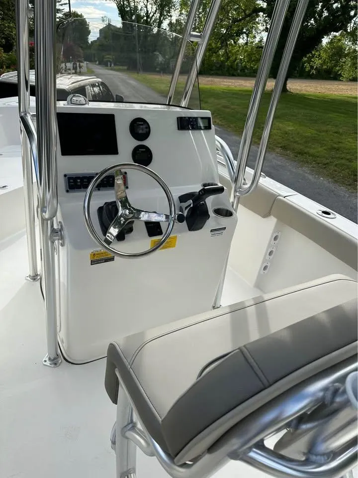 Slide: The Image of 2023 Key West 203 FS boat console with steering wheel and controls. - 6