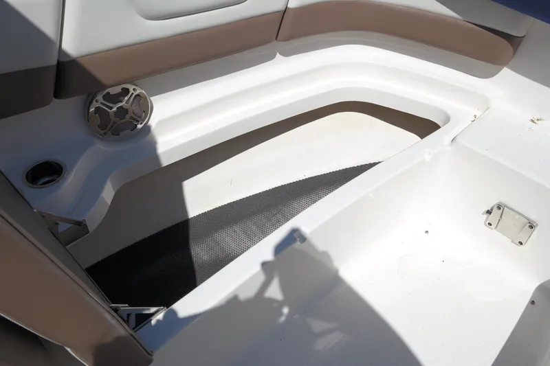 Slide: The Image of Interior seating area of 2015 Chaparral 250 Suncoast boat with speaker and cup holder. - 11