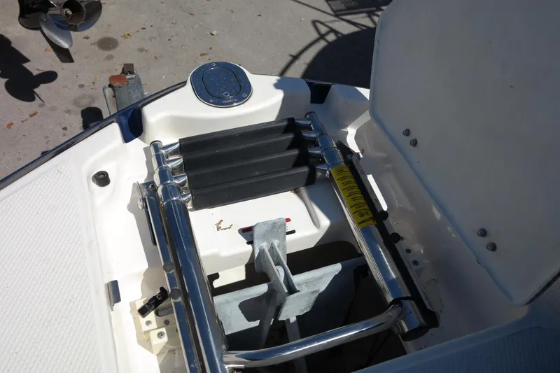 Slide: The Image of 2015 Chaparral 250 Suncoast boat ladder and anchor storage compartment. - 13