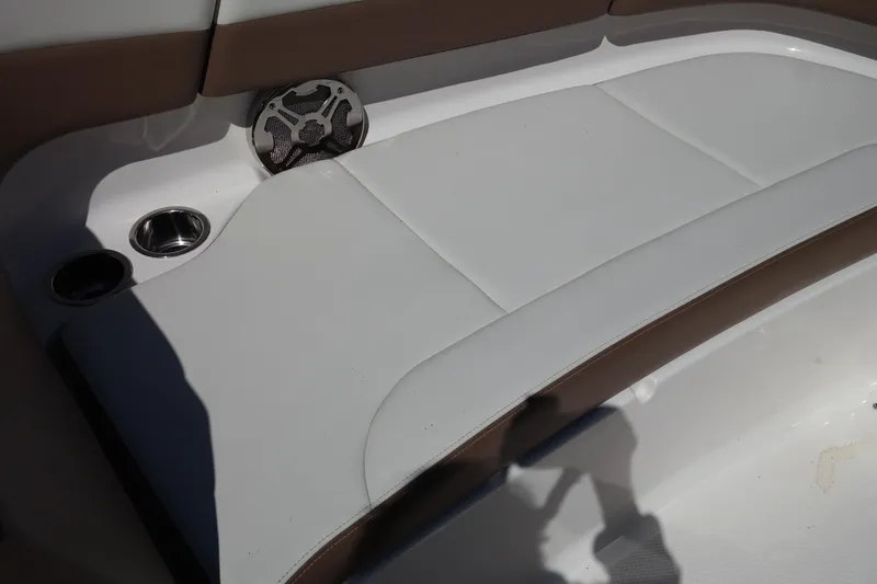 Slide: The Image of 2015 Chaparral 250 Suncoast boat interior with cushioned seating and speaker. - 16