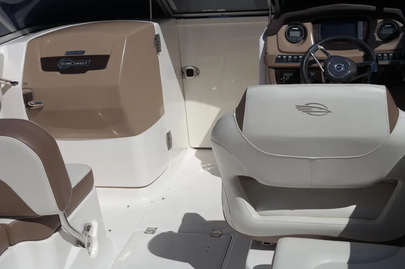 Slide: The Image of Interior of 2015 Chaparral 250 Suncoast boat with beige and white seating. - 19