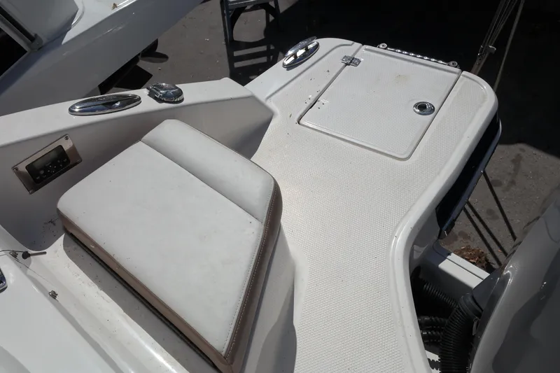 Slide: The Image of 2015 Chaparral 250 Suncoast boat deck with seating and storage compartment. - 21