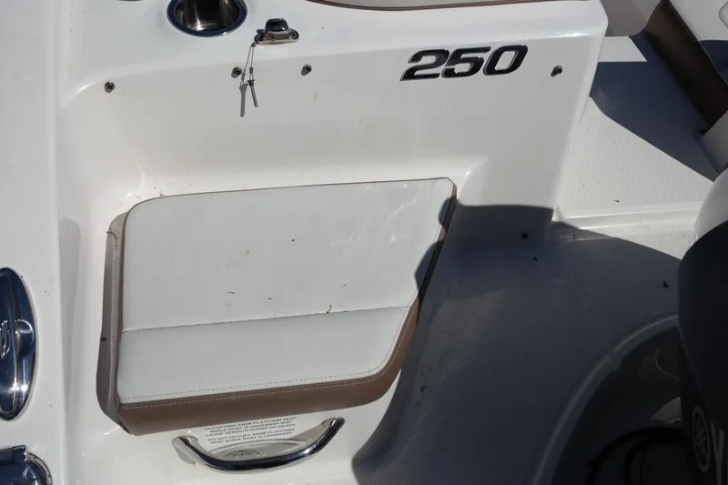 Slide: The Image of 2015 Chaparral 250 Suncoast boat interior detail with keys and seating. - 22
