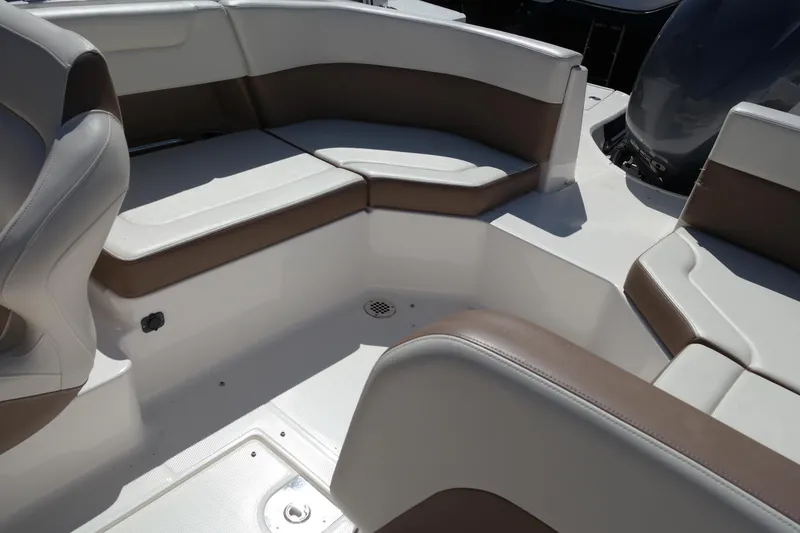 Slide: The Image of 2015 Chaparral 250 Suncoast boat interior with cushioned seating. - 24