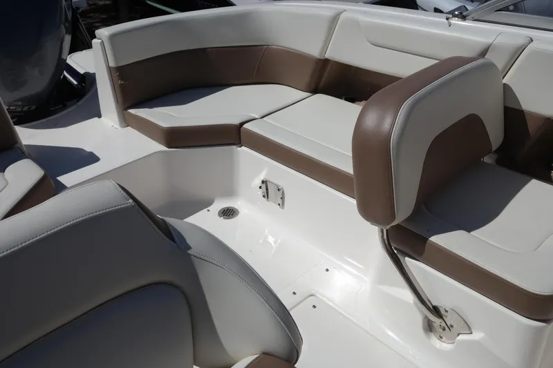 Slide: The Image of 2015 Chaparral 250 Suncoast boat interior with brown and white seating. - 25