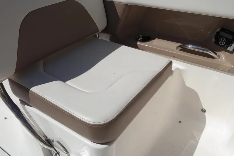 Slide: The Image of Chaparral 250 Suncoast 2015 boat seat with beige and white upholstery. - 27