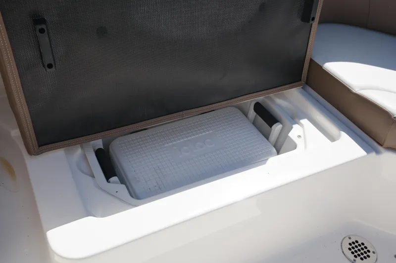 Slide: The Image of 2015 Chaparral 250 Suncoast boat storage compartment with cooler. - 29