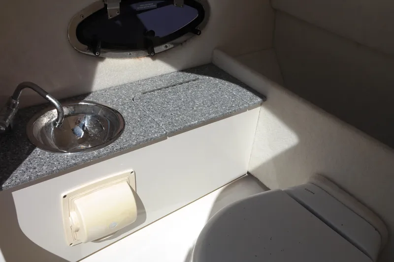 Slide: The Image of 2015 Chaparral 250 Suncoast boat interior with sink and toilet. - 3