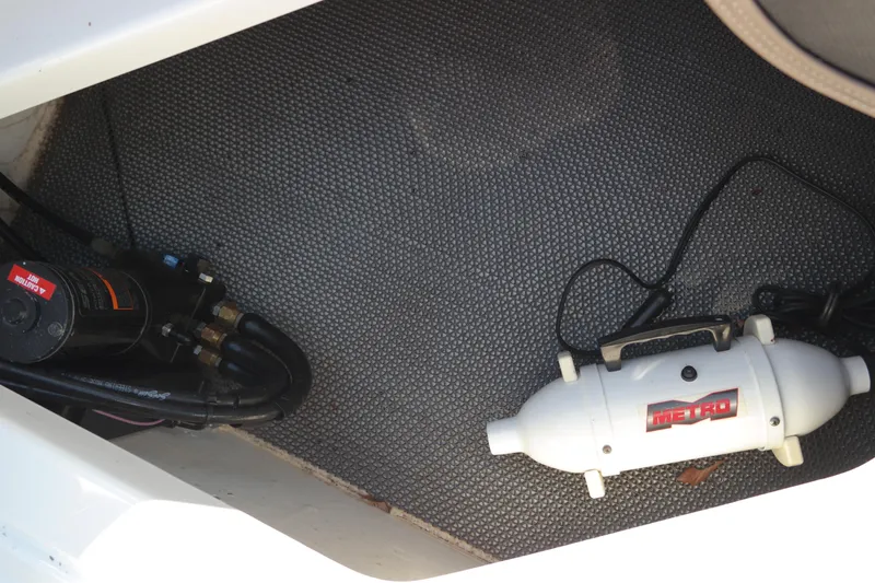 Slide: The Image of Storage compartment of 2015 Chaparral 250 Suncoast boat with equipment. - 30