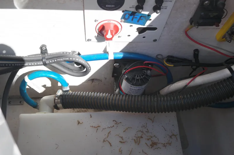 Slide: The Image of Electrical and plumbing components in a 2015 Chaparral 250 Suncoast boat. - 31
