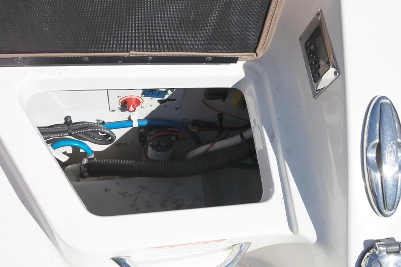 Slide: The Image of 2015 Chaparral 250 Suncoast boat compartment with visible wiring and components. - 32